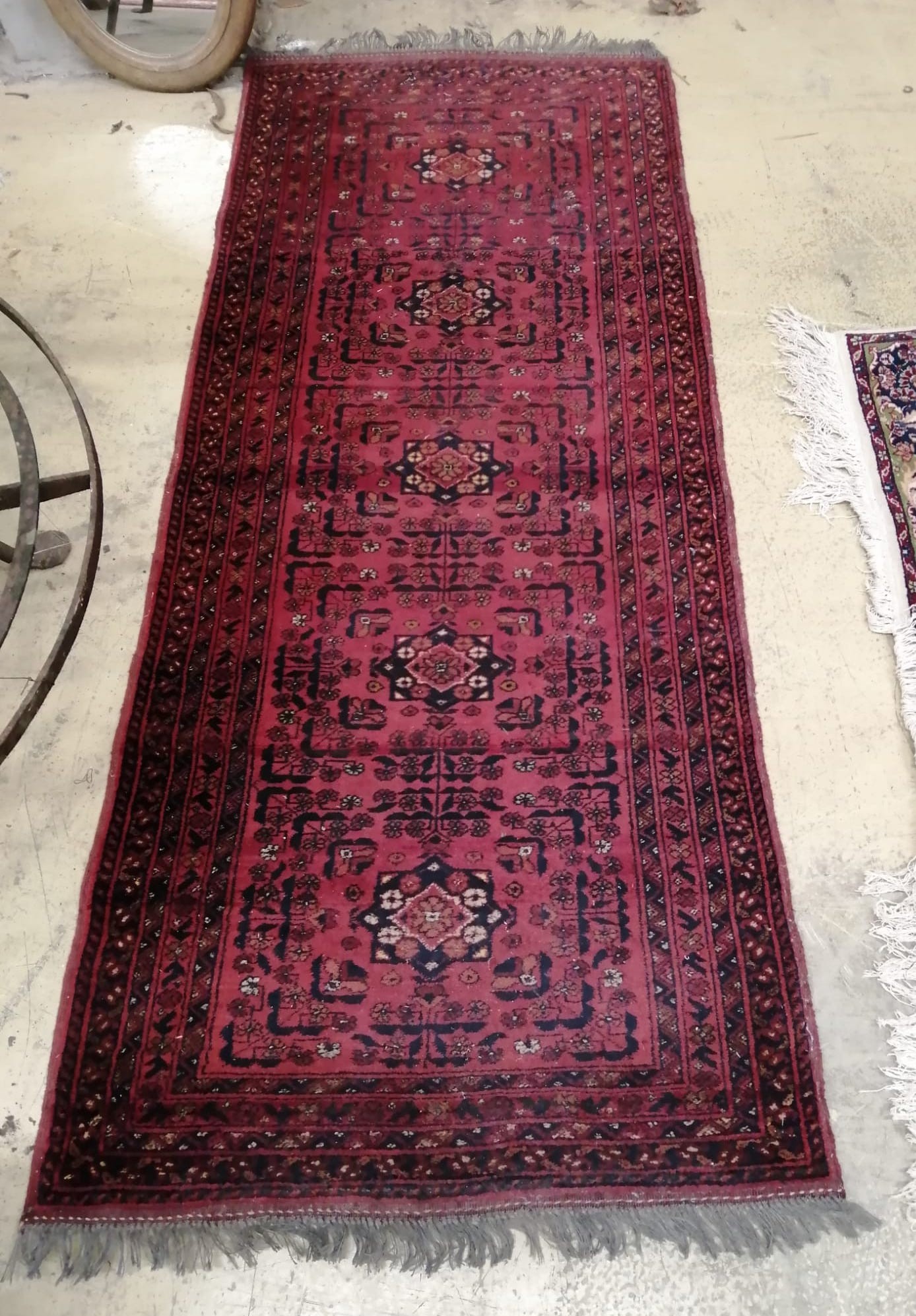 A Bokhara style red ground rug, 196 x 81cm